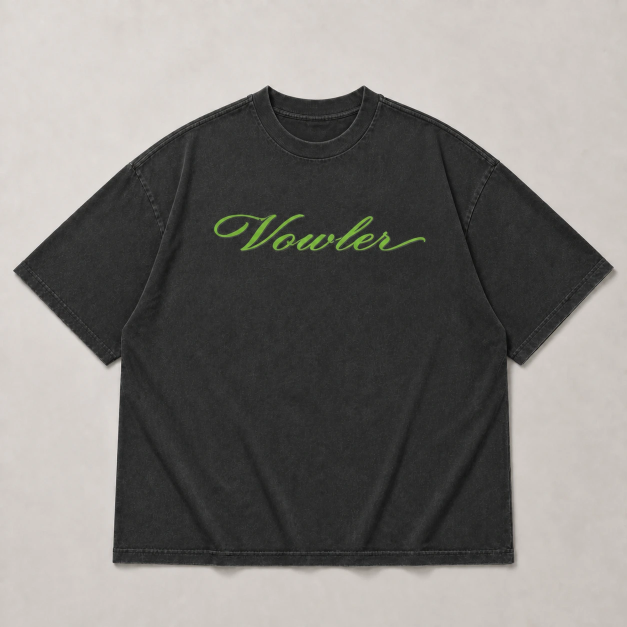Front of the oversized black Vowler T-shirt with a green Vowler wordmark
